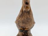 a wooden sculpture of a bird on a white background