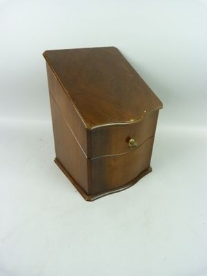 a small wooden box that is on a white surface