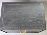an old black box sitting on top of a white table