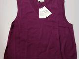 a close up of a purple sweater with a tag on it