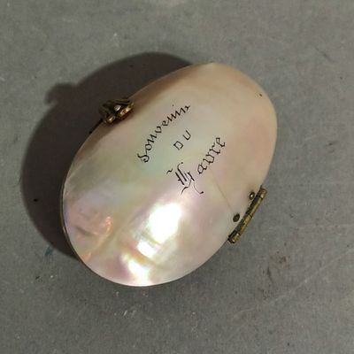 a white shell with writing on it sitting on a table