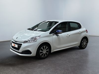 the small white car is parked in a large room