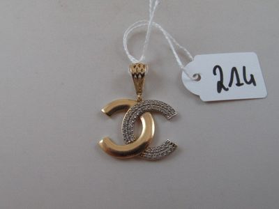 a gold and silver pendant with a chain attached to it
