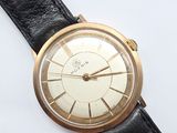 a gold and black watch on a black leather strap