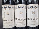 four bottles of wine are lined up on a table