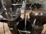 a picture of a hair salon with two chairs and a hair dryer