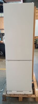 a white refrigerator sitting on a pallet in a warehouse