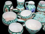 many different types of coffee cups and mugs on the table