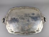 an antique silver tray with handles and handles on a white surface