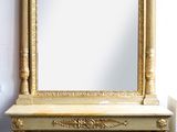 an image of a gold mirror sitting on top of a wooden table