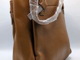 a brown bag with a plastic handle on it