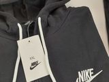 a close up of a black nike hoodie with a white nike logo on it