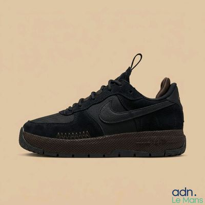 the nike air force 1 low is a black sued shoe with a brown sole