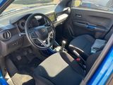 the interior of a small blue car with a steering wheel and dashboard