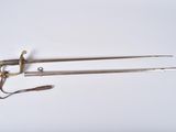 two swords and a sword on a white surface