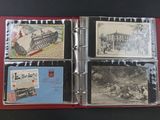 a red binder with a picture of a train and postcards on it