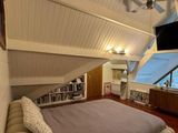 a large bed in the middle of a room with a flat screen tv on the wall