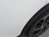 a close up of a tire on a white car