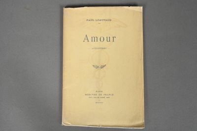 an old book sitting on top of a gray table