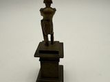 bronze figurine of a woman holding a vase on a pedestal