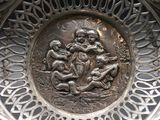 a silver plate with a picture of a man and a child on it
