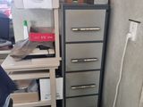 a man that is standing in front of a cabinet