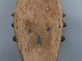 an image of a wooden mask on a gray background