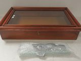a wooden box with a glass lid and a plastic bag