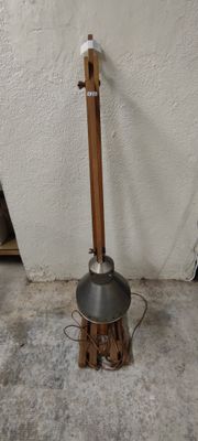 a lamp that is sitting on the ground next to a wall