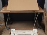 a cardboard box sitting on top of a table next to a air conditioner