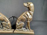 pair of antique bronze dog bookends on a black background