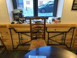 a table and chairs in front of a window with a car in the background