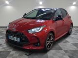 une Toyota Yaris rouge garée dans un showroom au sol carrelé