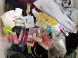 a pile of clothes and other items in a trash can