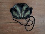 a black purse with a green and black design on it