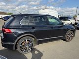 a black volkswagen suv parked in a parking lot