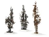 three metal sculptures of different shapes and sizes on a white surface