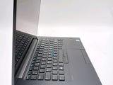 a laptop computer sitting on a table with a keyboard