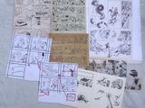 a lot of drawings on a sheet of paper on a bed