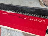 a person holding a skateboard with a red and black design on it