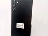 a close up of the back of a black phone with a sticker on it