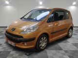 an image of a small orange car parked in a garage