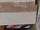 a cardboard box with a sign on it sitting on the floor