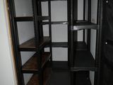 a small room with shelves and a door in it