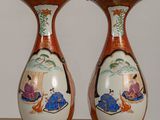 two vases that are sitting on a table