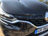the front end of a black car with a number plate on it