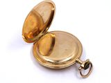 an image of a gold pocket watch on a white background
