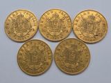 four gold sovereigns of different sizes and shapes