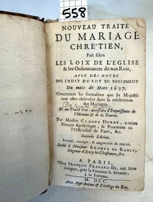 an old book with writing on it sitting on a table
