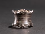 a silver ring that is sitting on a table
